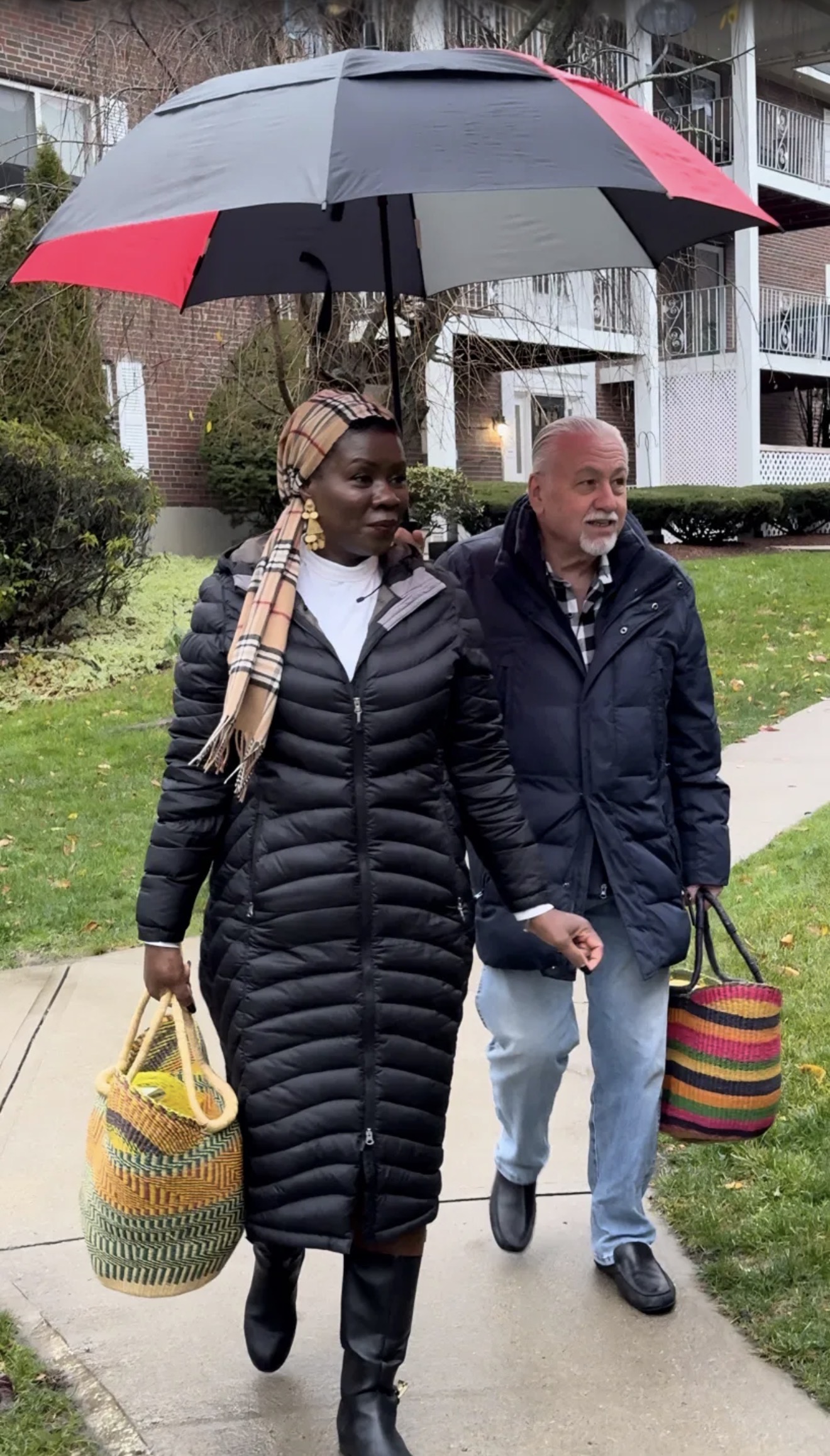 Cynthia and her husband carrying baskets during their annual Thanksgiving turkey giveaway