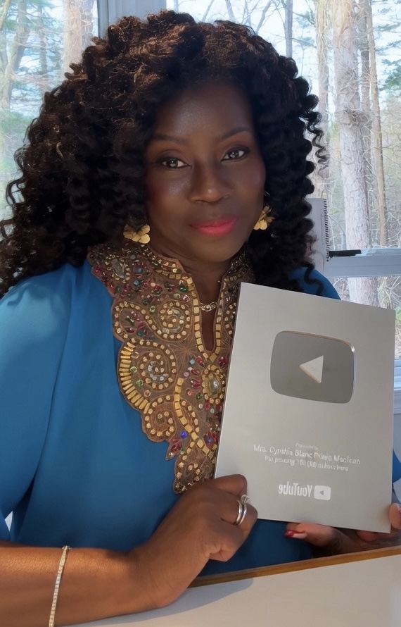Cynthia holding her YouTube Creator Award